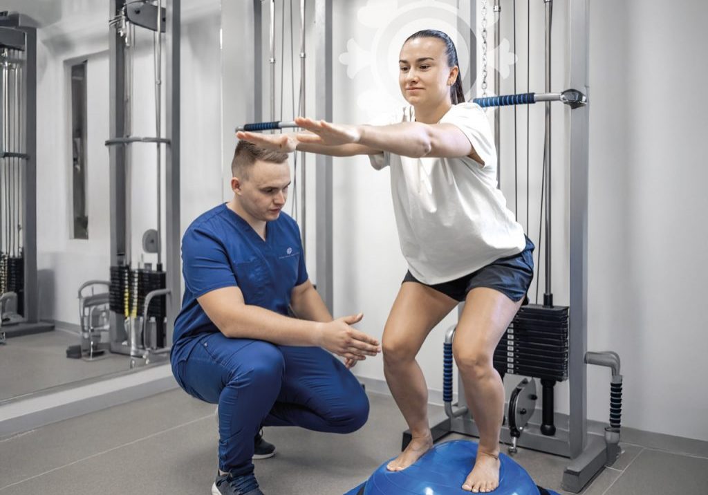 Physiotherapist helping female patient with rehabilitation, balance exercise with bosu ball, woman and doctor during rehab physiotherapy in gym.
